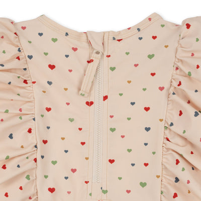 MANUCA FRILL ONESIE MULTI HEARTS